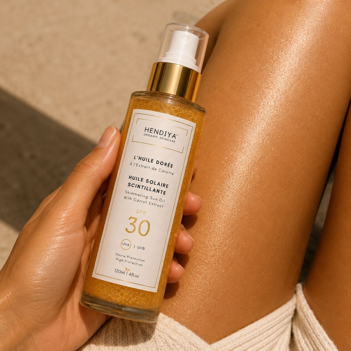 Application of L'Huile Dorée, shimmering sun oil by Hendiya, on the skin